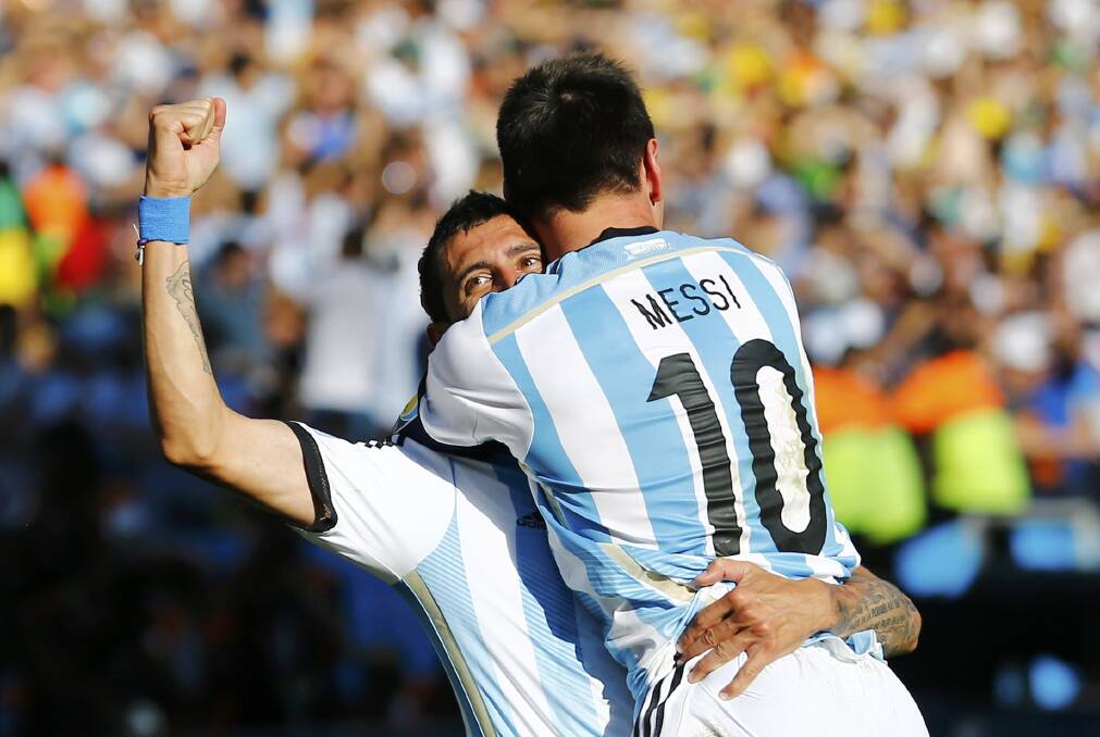 Lionel Messi celebrates with Angel Di Maria after he scored in extra time against Switzerland in Sao Paulo. Picture: REUTERS