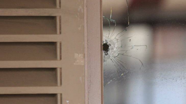 The bullet hole in the window of Billu's Indian Eatery in Wigram Street, Harris Park. Photo: Peter Rae
