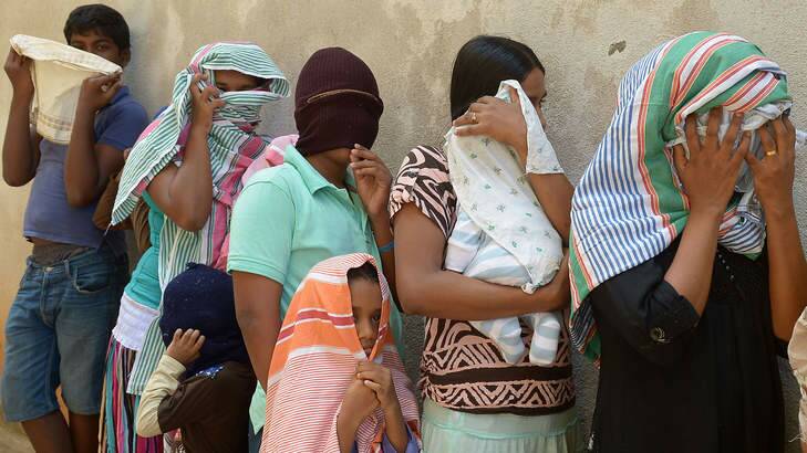 Sri Lankan asylum seekers sent back by Australia queue to enter the magistrate's court in the southern port district of Galle, Sri Lanka, in July. Photo: Lakruwan Wanniarachchi/AFP