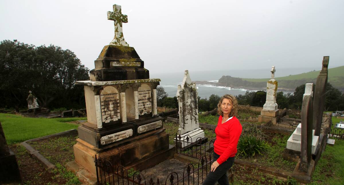 Sue Lark at the graves of two priests who drowned in Kiama in 1883. Picture: GREG TOTMAN