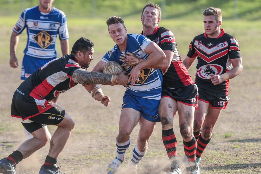 Thirroul's Leigh Higgins is wrapped up by the Collegians defence. Picture: ADAM McLEAN