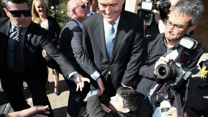 Chas Licciardello falls at the feet of Mr Turnbull. Photo: Andrew Meares