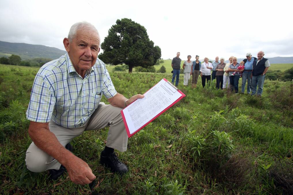 Reg Curnow with a petition from Jamberoo residents who are concerned about a proposed residential development in the town. Picture: ROBERT PEET
