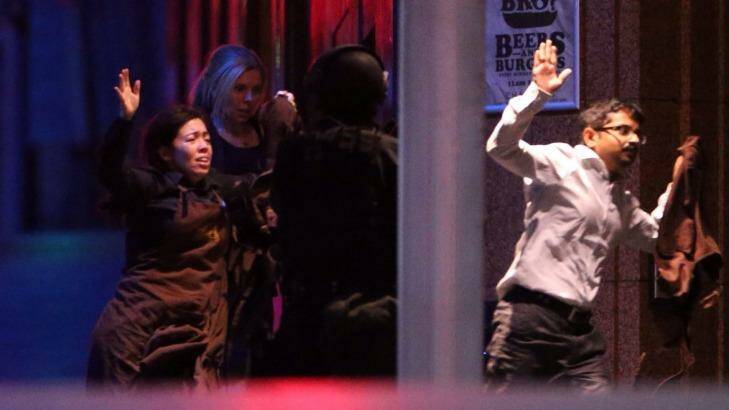 Freed hostages run from the Lindt Chocolat Cafe in Martin Place. Photo: Andrew Meares