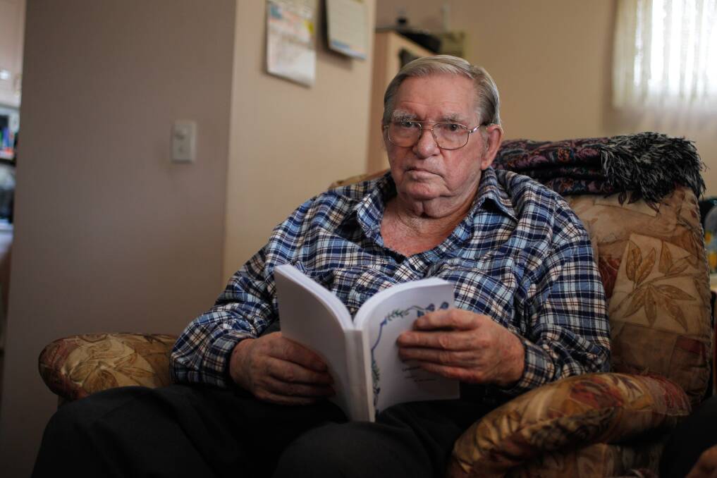 Allan Johnston with one of several books he has written after turning to writing to relieve the boredom during an extended hospital stay. Picture: CHRISTOPHER CHAN