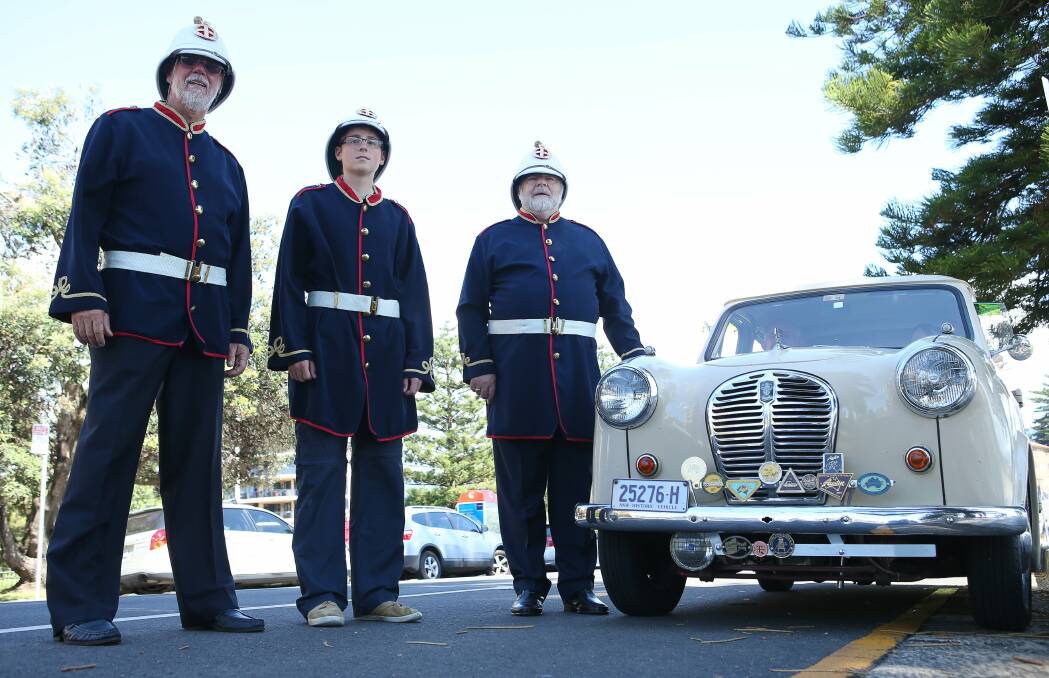 Rotary Illawarra Sunrise members Rhys Gray, Jan Clive-Schmidt and Brian Ash (with a 1954 Austin A30) will lead the gun battery march on Australia Day. Picture: KIRK GILMOUR