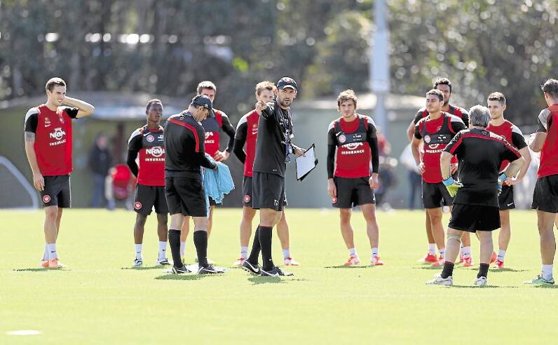 Tony Popovic directs his players during a training session at Rooty Hill, Sydney, on Tuesday. Picture: ANTHONY JOHNSON