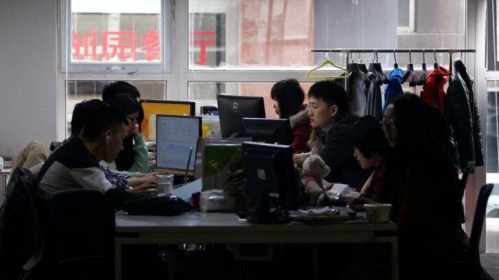 Workers use computers at their desks inside Tech Temple, a co-working space for start-up companies, in Beijing. Photo: Tomohiro Ohsumi/Bloomberg