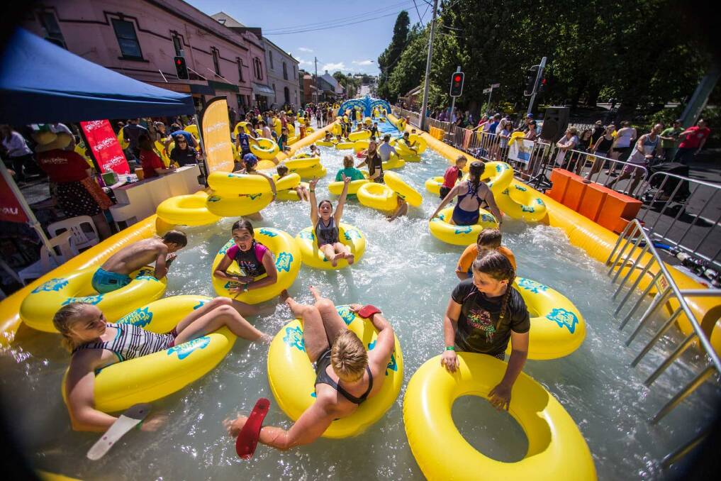 Children enjoy the City Slider in Launceston recently. The 325-metre water slide will be in Port Kembla on  Saturday and Sunday.