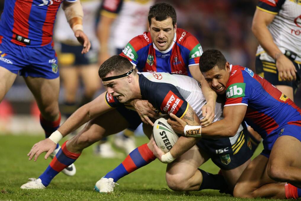 Ethan Lowe of the Cowboys is tackled by the Knights' defence at Hunter Stadium on Monday night. Picture: GETTY IMAGES