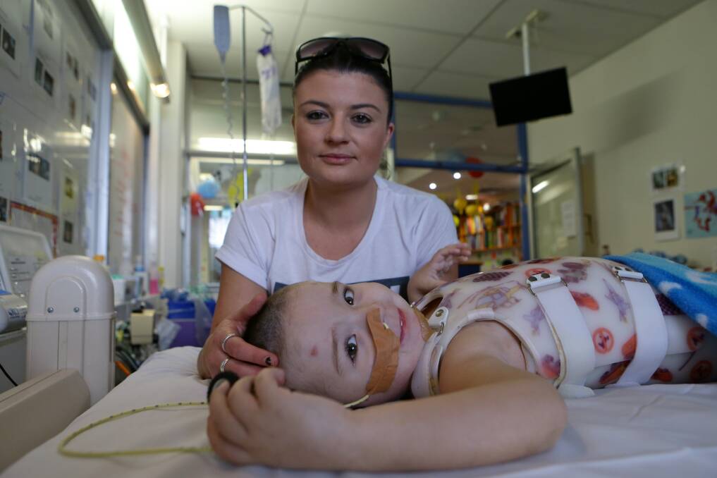 Bomaderry's Sarah O'Meara with her son Jake Price, 3, who is recovering after suffering head and spinal injuries in a car accident in April. Picture: DALLAS KILPONEN