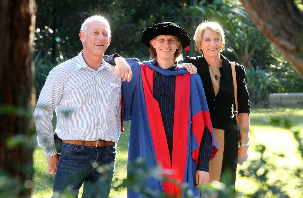 Rich reward: Julian Fyfe with parents Iain and Crissy at the University of Wollongong's mid-year graduation ceremony. Picture: ROBERT PEET