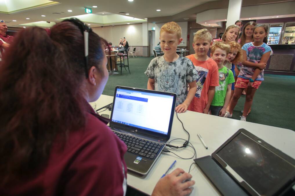 Busy: Eamon Everett, 8, (front of queue) with other children registering to play for the Unanderra Hearts Soccer Club at Wests Illawarra Leagues Club on Saturday. Picture: ADAM McLEAN