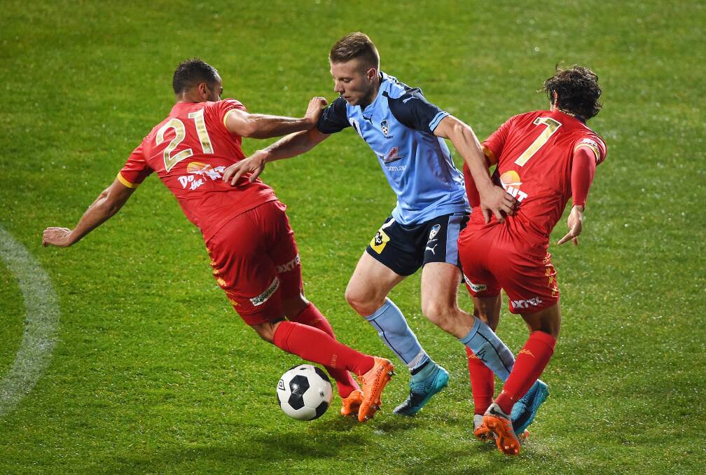 Sydney's Andrew Hoole, centre, competes for the ball against Adelaide's Tarek Elrich and Pablo Sanchez Alberto. Picture: GETTY IMAGES