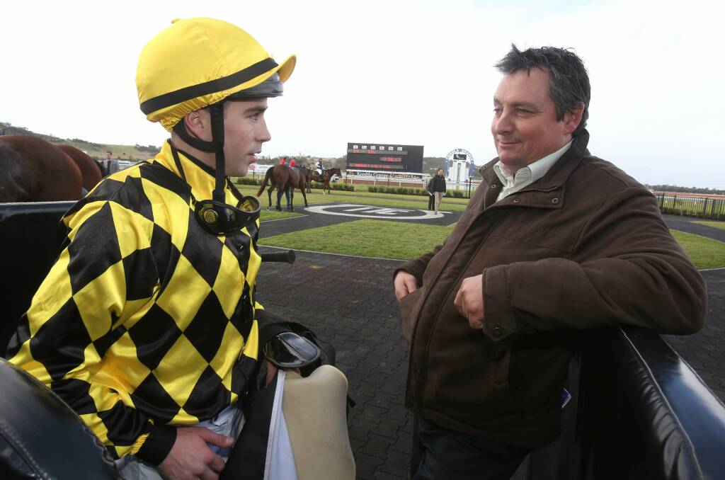 Jockey Adam Hyeronimus talks with assistant trainer Barry Wintle after his victory. Picture: ROBERT PEET