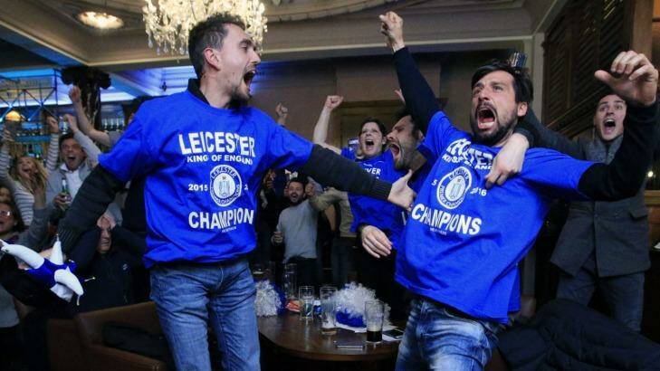 Leicester City fans celebrate in Hogarths public house in Leicester after Chelsea's Eden Hazard scores the equalising goal against Tottenham Hotspur, delivering the Foxes the Premier League championship. Photo: Jonathan Brady