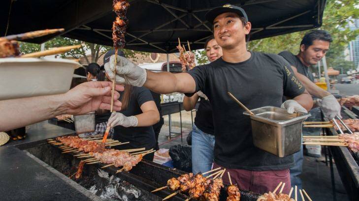Taste that: Budz leads the cooking team at the Hoy Pinoy Filipino barbecue at the Lunar Markets. Photo: Simon Schluter