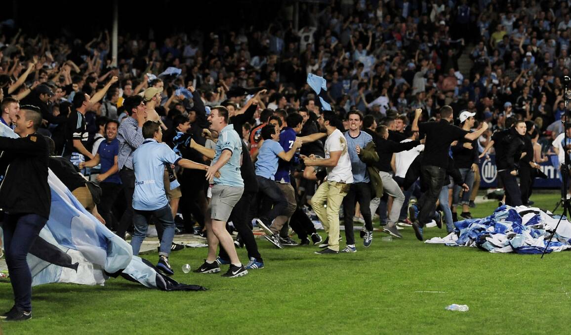 Children were among the Sydney FC supporters that burst on to the pitch while the game against Western Sydney still had 10 minutes to play. Picture: GETTY IMAGES