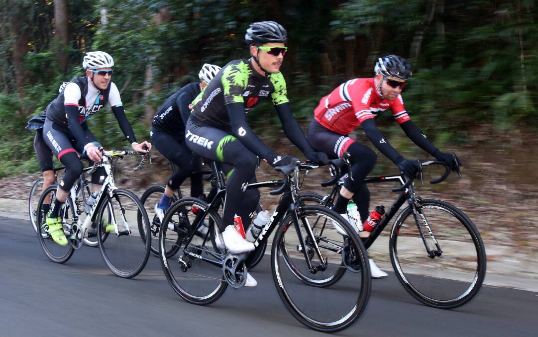 Kyle Ward (in black and green) cycling with a group up and down Mount Keira during the Everesting Challenge to raise money for Nepal. Picture: ROBERT PEET