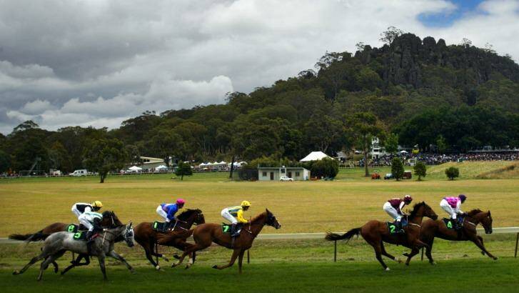 Horses race under the shadow of Hanging Rock.
 Photo: Jason South