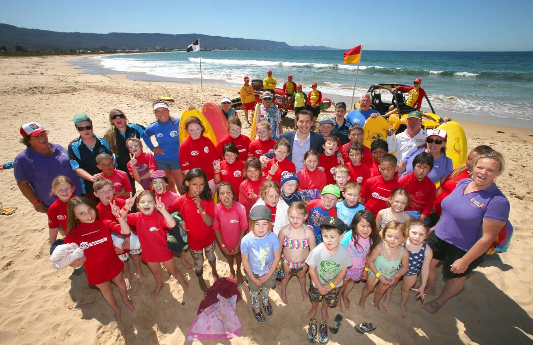 Children gather on Bellambi Beach with lifesavers, instructors and MP Ryan Park to learn about surf awareness. Picture: KIRK GILMOUR