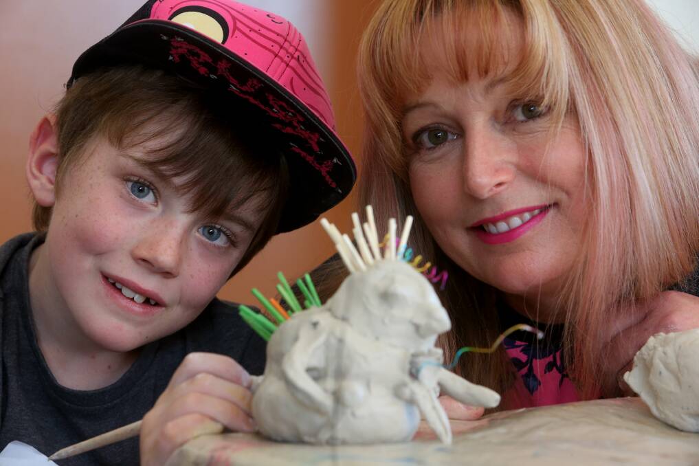 Aden Carmichael, 8, with artist and workshop educator Tina MacKander, transforms clay into monsters at the Wollongong Art Gallery. Picture: ROBERT PEET