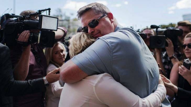 Peter and Rebecca McNeill hug after a jury found their son's killers guilty of his murder. Photo: Christopher Pearce