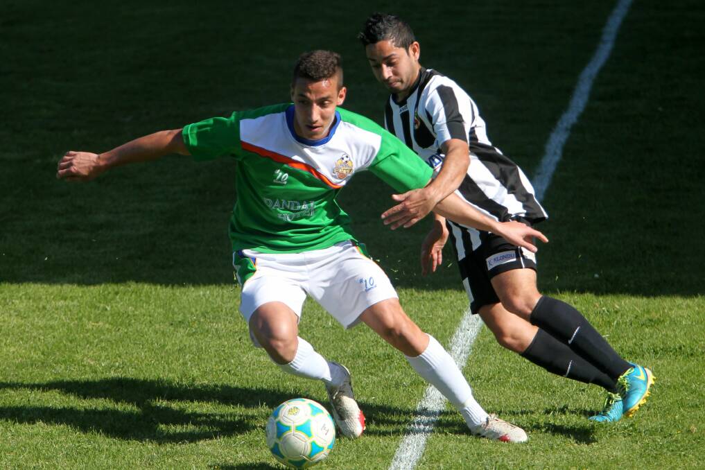 Dapto-Dandaloo's David Hartas and Port's William Mobbs  in action on Sunday. Picture: GREG TOTMAN