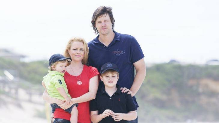 Battle over insurance: Former test cricket player Nathan Bracken with his wife Haley and boys Chase and Tag. Photo: James Brickwood