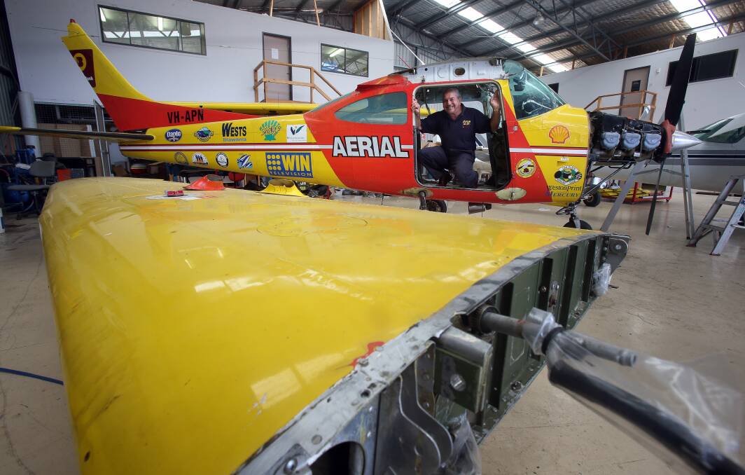 Harry Mitchell with the aerial patrol plane undergoing a compulsory inspection ahead of the summer season. Picture: ROBERT PEET