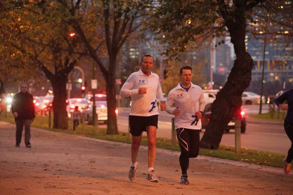 Prime Minister Tony Abbott, seen out jogging in Melbourne on Friday, said the government stopped people-smuggler boats ''by hook or by crook''. Photo: Josh Robenstone