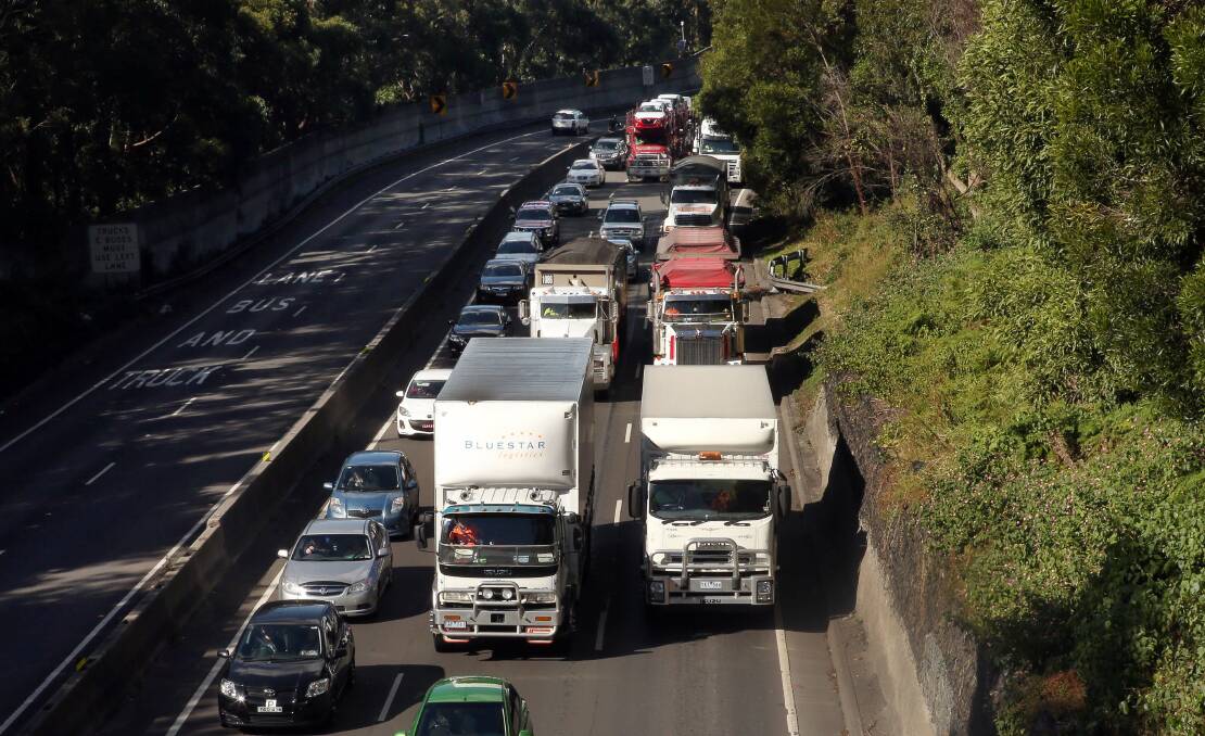 Banked up traffic slowly heads up Mount Ousley near the New Mt Pleasant bridge after a truck caught on fire in the northbound lanes of the M1. Picture: KIRK GILMOUR