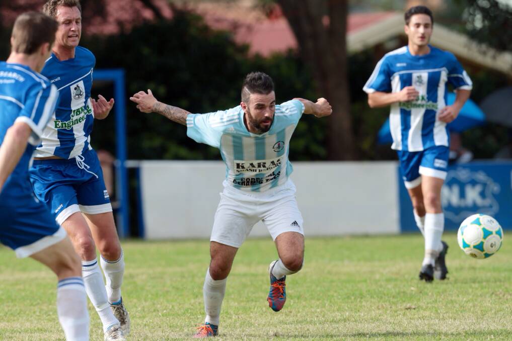 Wollongong Olympic's Mark Picciolini has eyes only for the ball during his team's 3-1 loss to Tarrawanna. Picture: ADAM MCLEAN