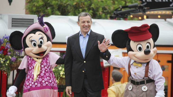 Disney CEO Robert Iger with Minnie Mouse and Mickey Mouse: Will he extend his tenure now? Photo: NYT