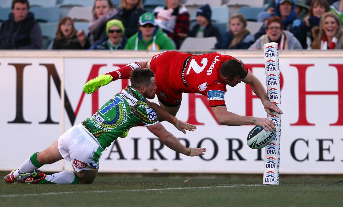 Dragons' flyer Brett Morris soars through the air to score in the corner against the Raiders in Canberra on Saturday.Picture: GETTY IMAGES