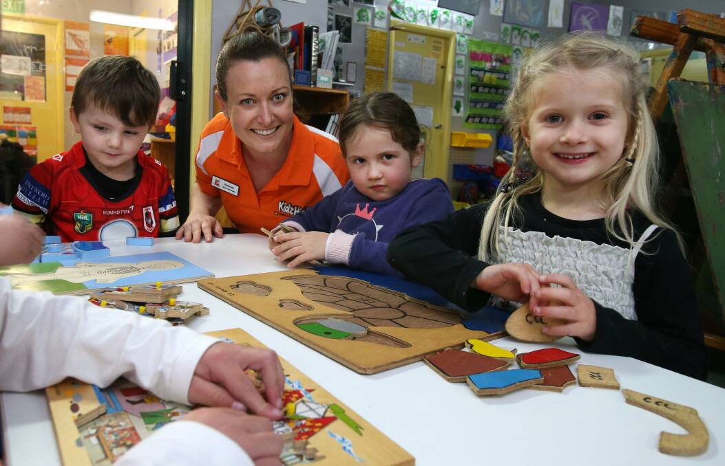 KidzWish speech pathologist Susannah Jennings and preschoolers Braxton, Sophia and Olivia have some fun at Coolgardie Child Care Centre in Corrimal.Picture: KIRK GILMOUR