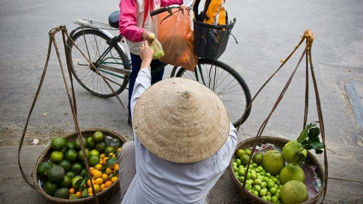 A street vendor sells fruit in Ho Chi Minh City. Photo: Chris Bolin