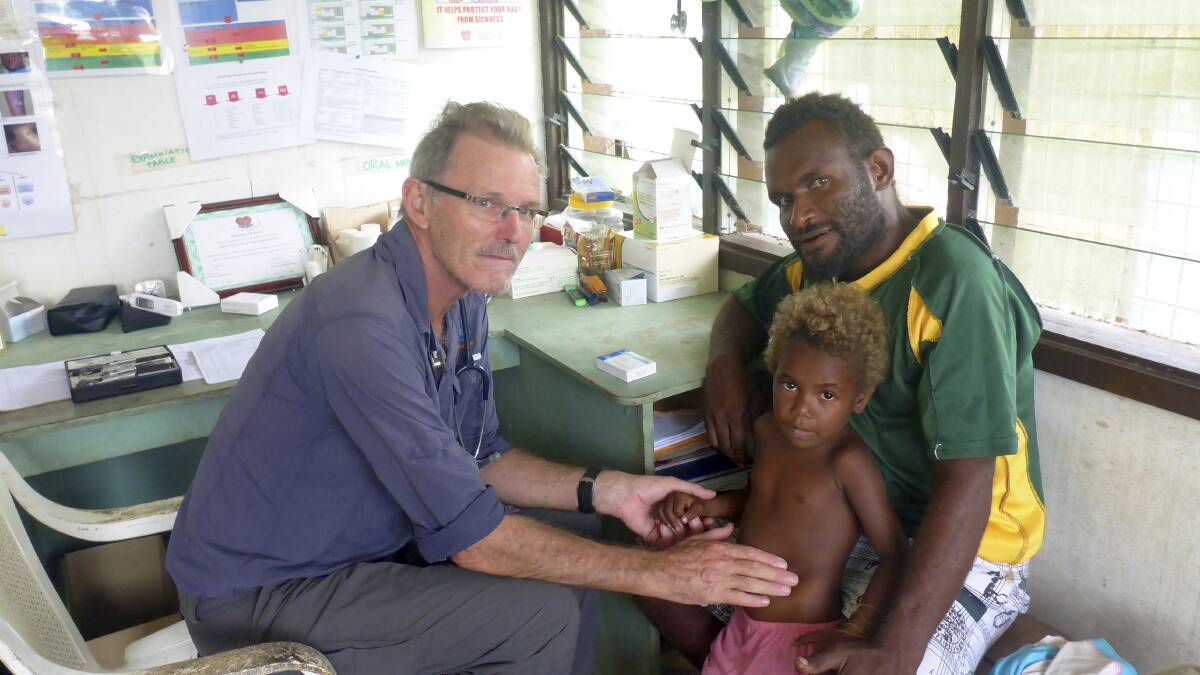 Dr Max Osborne with a young patient and his father in Papua New Guinea, where he has been volunteering.