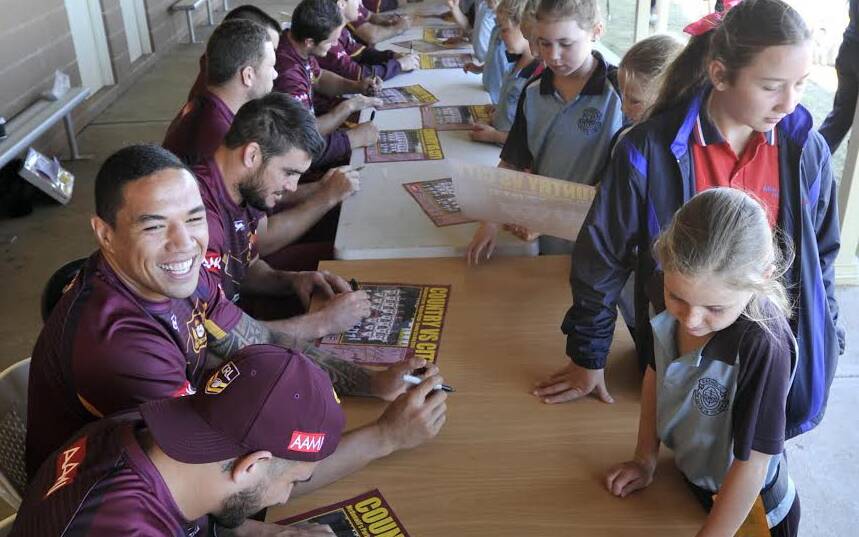 Tyson Frizell and his Country team-mates autograph team posters for young fans in Wagga Wagga. Country will take on their City counterparts in the Riverina city on Sunday. Picture: LES SMITH