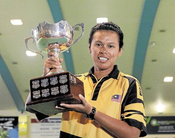 Siti Zalina Ahmad representing Malaysia with the winners trophy. Picture: ANDY ZAKELI