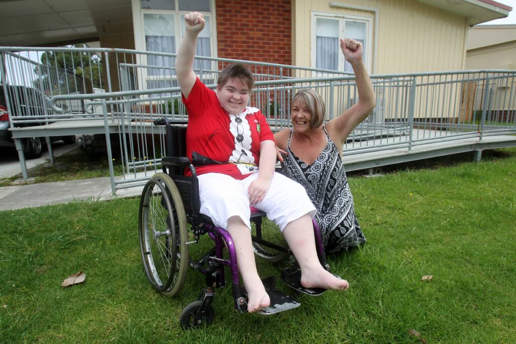 Shai Robinson and mum Kerri celebrate the stolen chair's return.Picture: GREG TOTMAN