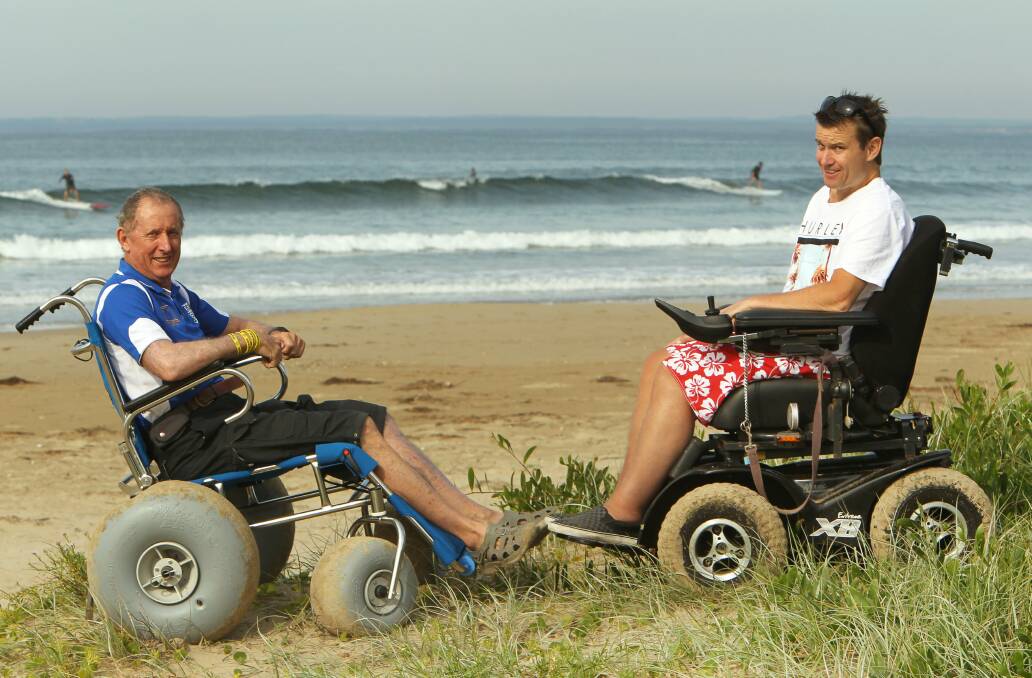 Jim Bradley, from the Disabled Surfing Association, with Andy Farrell after taking delivery of a new beach wheelchair. Picture: KIRK GILMOUR