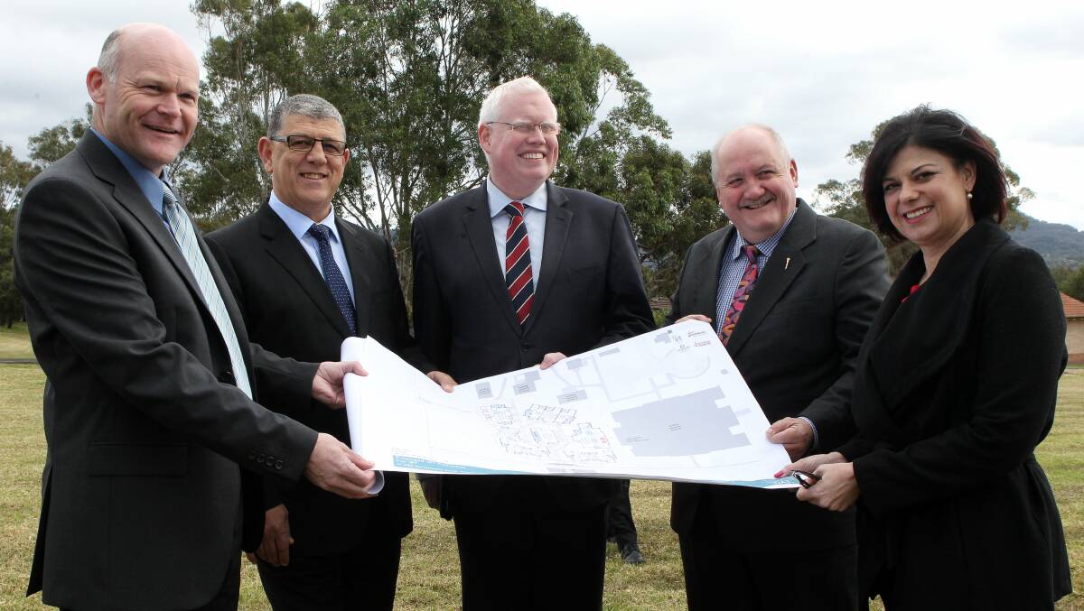 IRT Group's Darren Jackson, Minister for the Illawarra John Ajaka, Kiama MP Gareth Ward, Heathcote MP Lee Evans and IRT chief executive Nieves Murray look at the plans. Picture: GREG TOTMAN