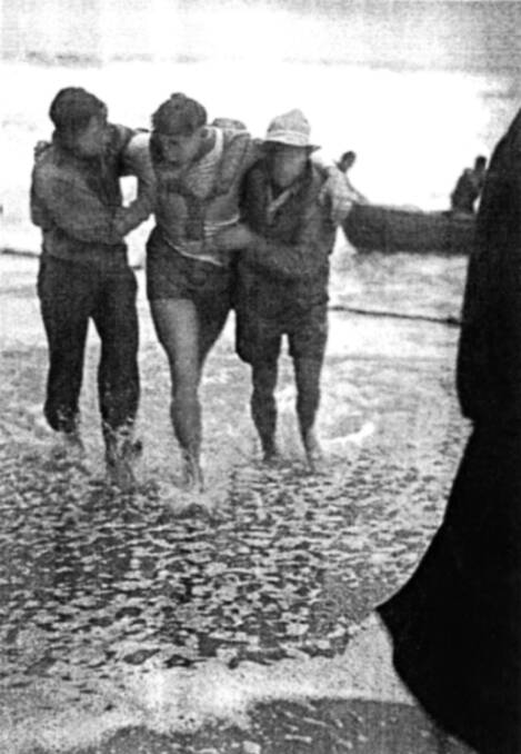 Bruce Smith being helped from the water after he rescued a crew-mate during the search operation following the sinking of the SS Bombo in 1949