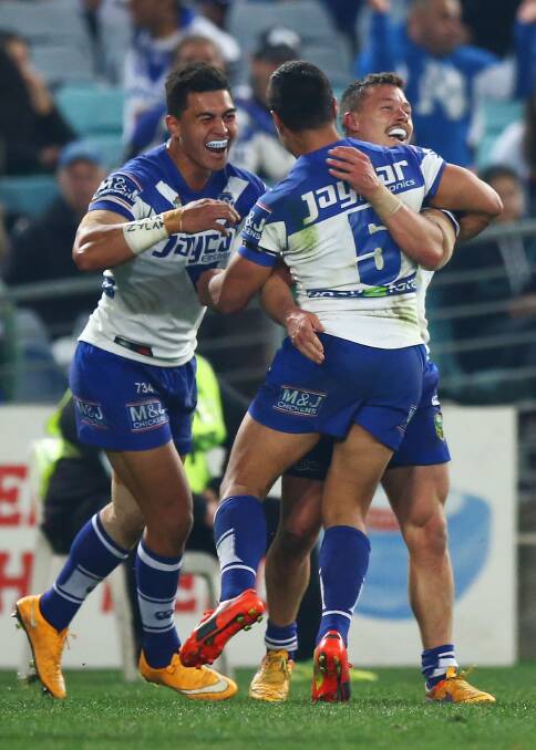 SYDNEY, AUSTRALIA - AUGUST 21:  The Bulldogs celebrate a try by Sam Perrett during the round 24 NRL match between the South Sydney Rabbitohs and the Canterbury Bulldogs at ANZ Stadium on August 21, 2015 in Sydney, Australia.  (Photo by Mark Nolan/Getty Images)