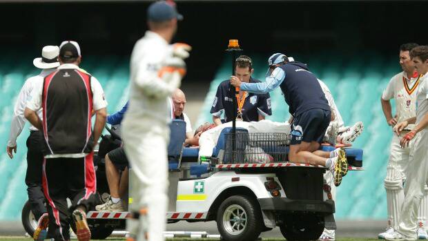 Phil Hughes is stretchered off the SCG. Photo: Getty Images