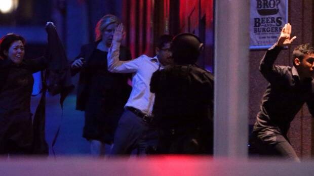 Hostages flee after police raided the Lindt cafe. Photo: Andrew Meares