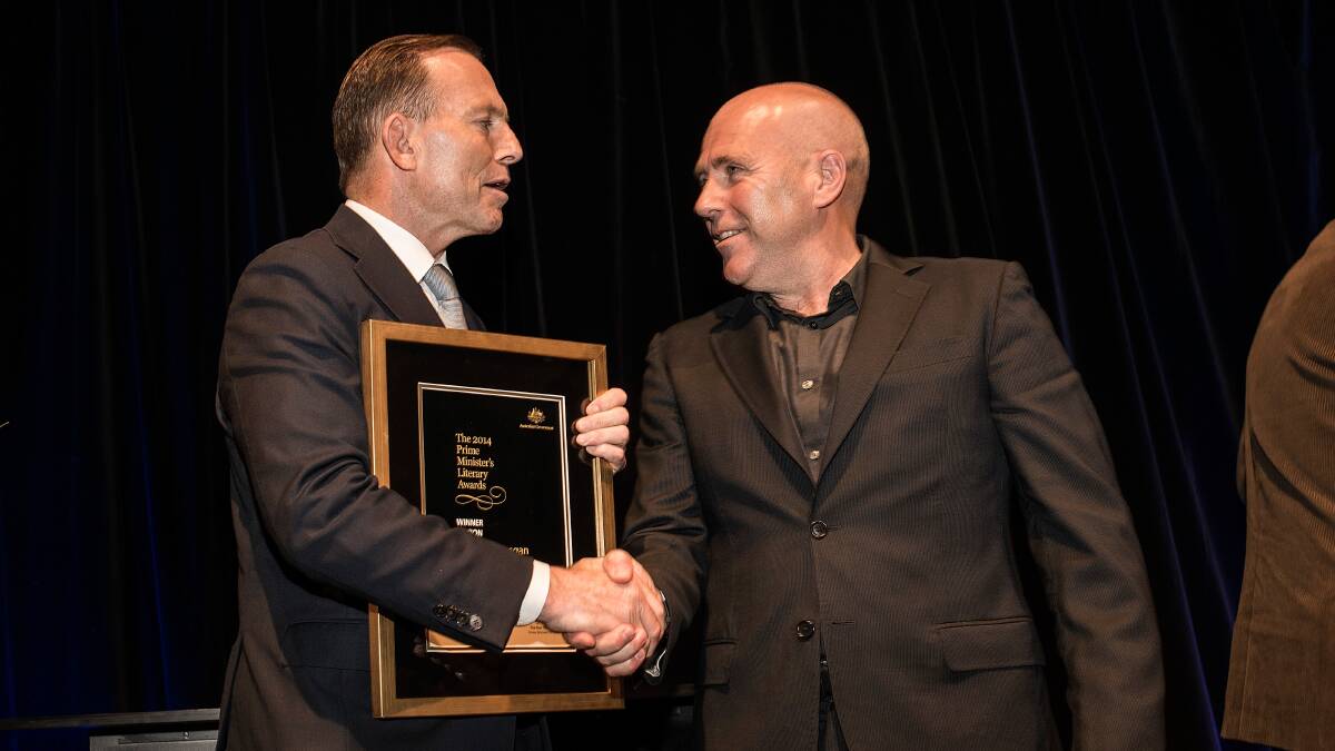 Tony Abbott hands Richard Flanagan the Prime Minister's Literary Award for fiction. Picture: JOSH ROBENSTONE