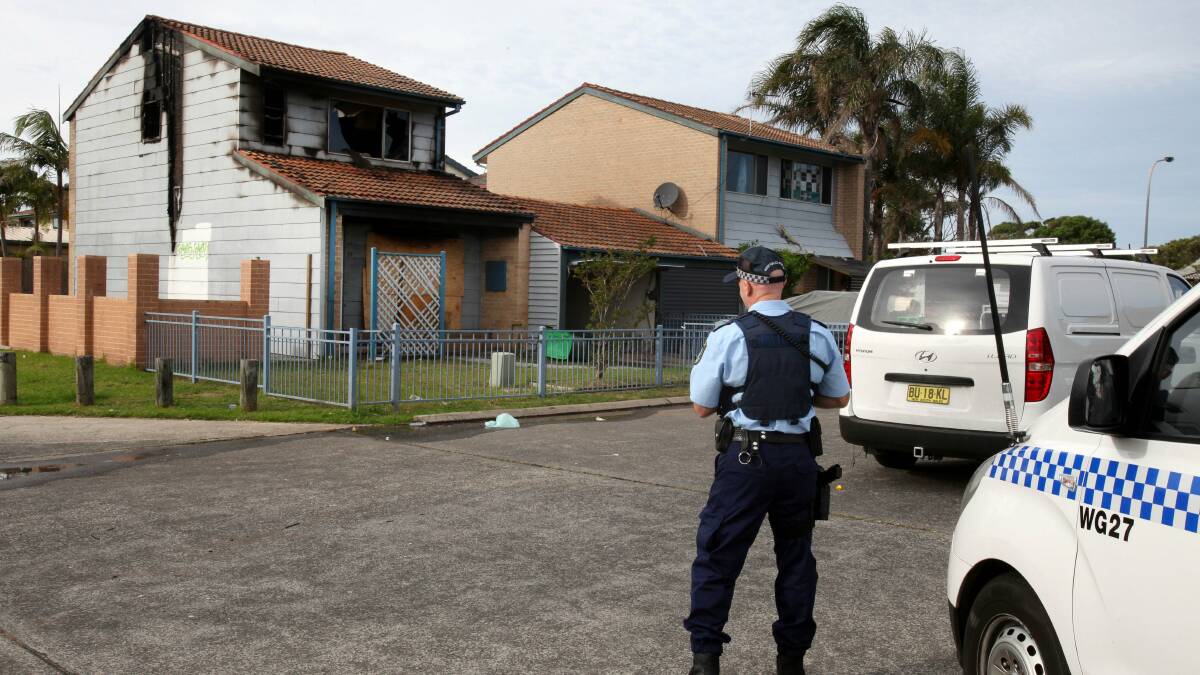 Police inspect the Bellambi house that was gutted by a fire on Thursday. Picture: KIRK GILMOUR