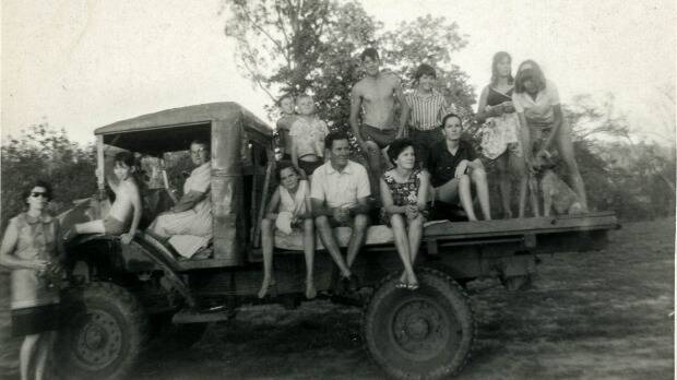 Pamela Parker aged 12 sitting on the back of a truck at Fletcherview with her legs over the edge; her parents are to her left. Olive's mother, Granny Chapman, is in the driver's cab. Photo: Courtesy of Pam Parker